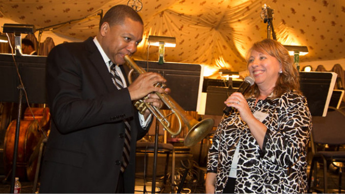 Wynton Marsalis holding a trumpet next to Celesta Billeci.