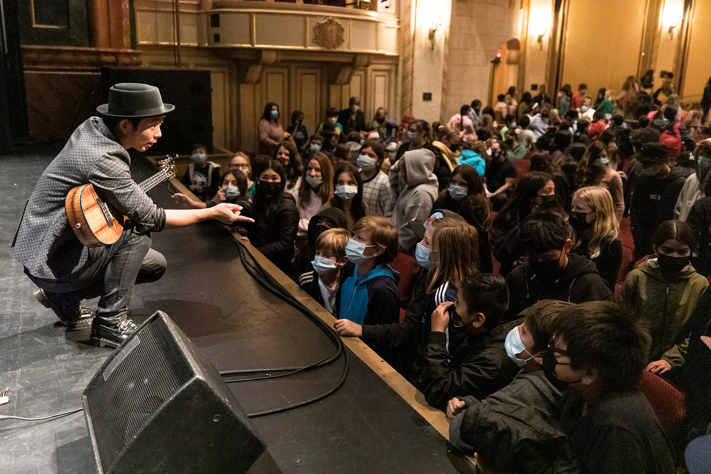Jake Shimabukuro answers questions from elementary school students at the Granada Theatre as part of A&L's  Arts Adventures bus-in program.